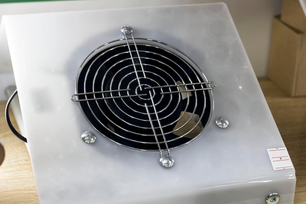 The fan with a grid in a white plastic frame