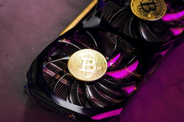 On the fans of a powerful video card, the coins of the Bitcoin cryptocurrency with a red backlight are displayed