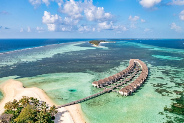 Fantastic aerial island landscape, luxury tropical resort, pier water villas beautiful sea bay