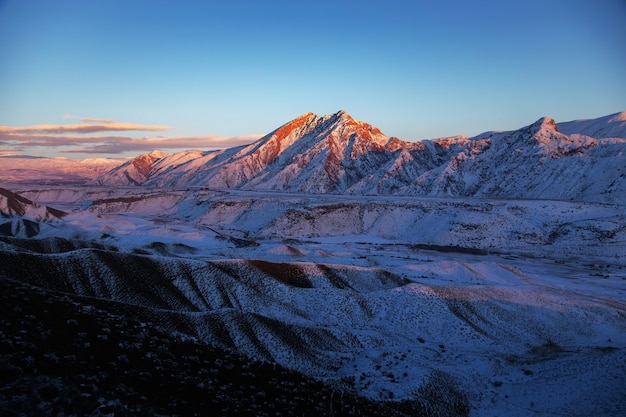 Fantastic evening winter landscape Snowy mountains at the sunset