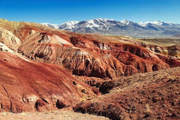 Fantastic red mountains with bright color transitions and blue sky in place named Mars 1 Altai