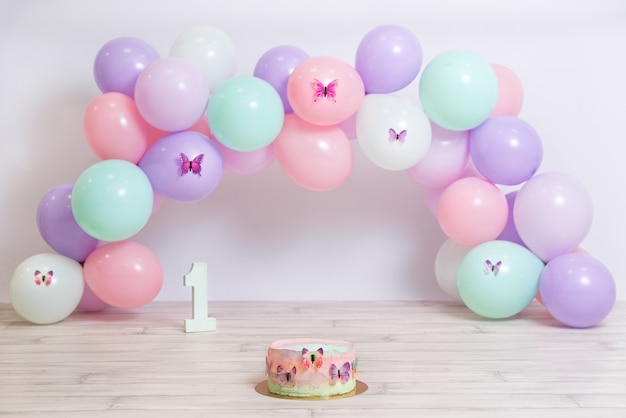 Foto fantastische kleurrijke verjaardagstaart met pastelkleurige ballonnen vlindertaart verjaardagsfeestje voor het meisje