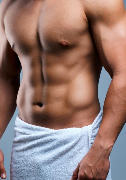 A fantasy of all seasons Cropped shot of an unrecognizable man posing in a towel against a grey background