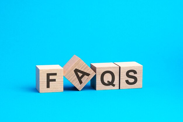 Faqs text on wooden blocks business concept blue background