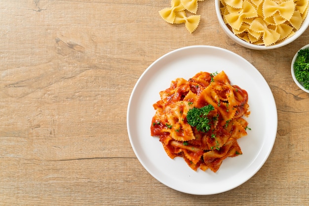 farfalle pasta in tomato sauce with parsley - Italian food style