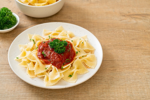 farfalle pasta in tomato sauce with parsley - Italian food style