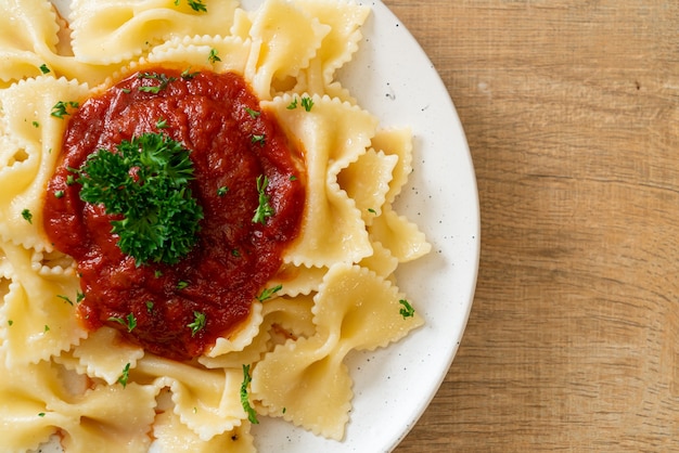 farfalle pasta in tomato sauce with parsley - Italian food style