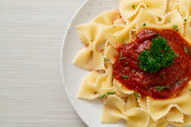 Farfalle pasta in tomato sauce with parsley