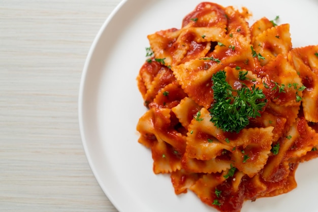 Farfalle pasta in tomato sauce with parsley