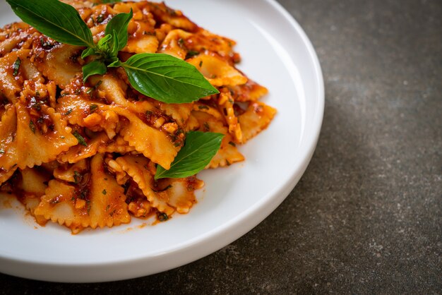 farfalle pasta with basil and garlic in tomato sauce - Italian sauce