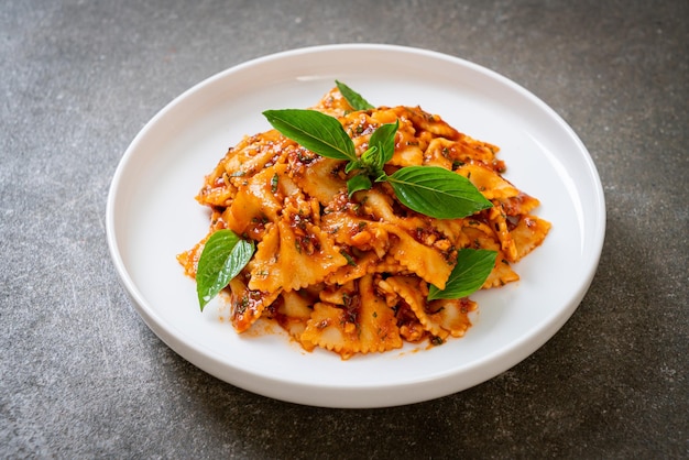 farfalle pasta with basil and garlic in tomato sauce - Italian sauce