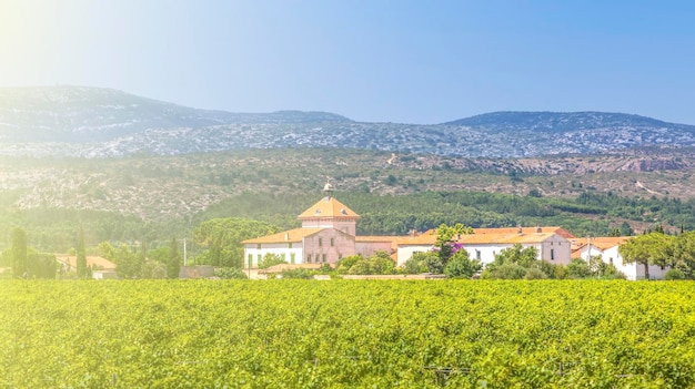 Farm in france against the backdrop of hills and blue sky in soft sunlight