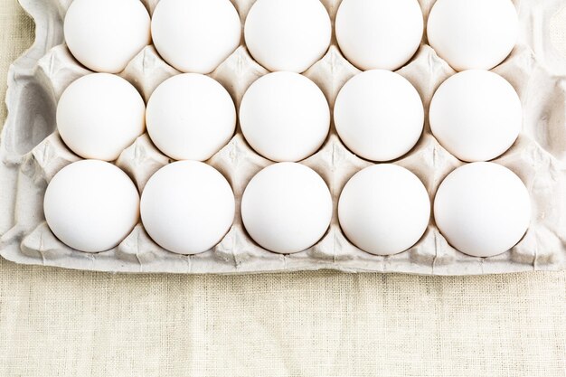 Photo farm fresh organic white eggs in egg crate.