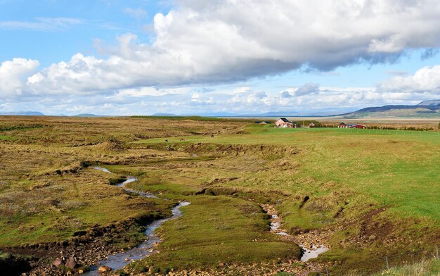 Farm with Icelandic grazing horses in the valley, Iceland. Europe