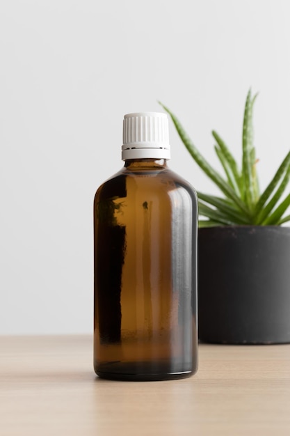 Farmaceutische fles mockup met een vetplant op de houten tafel