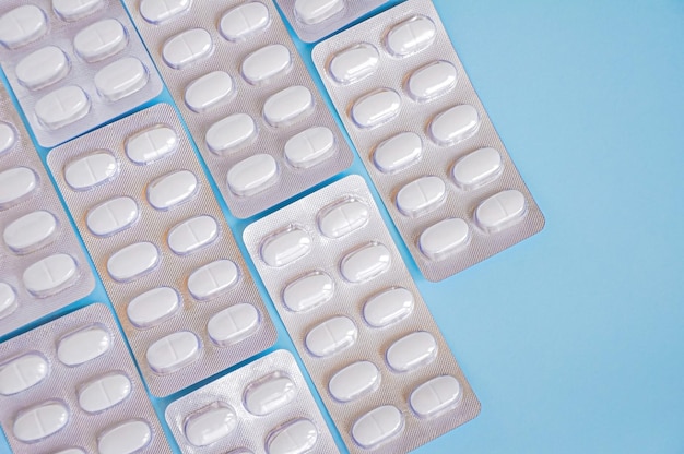 Farmaceutische medicatie en medicijnpillen in pakken op blauwe bedelaars
