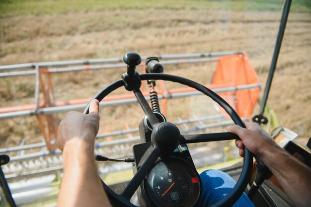 Farmer controls the combine harvester