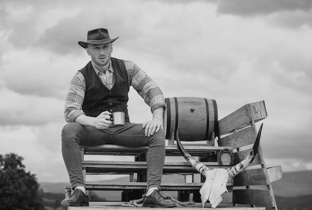 Farmer cowboy hold cup coffee or tea western life american country male portrait farm owner worker i