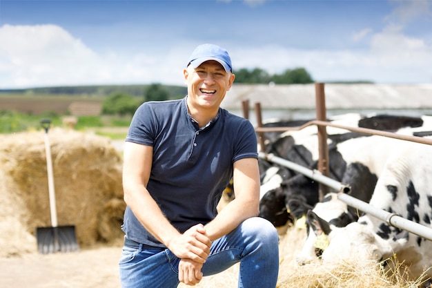 Photo farmer at farm with dairy cow