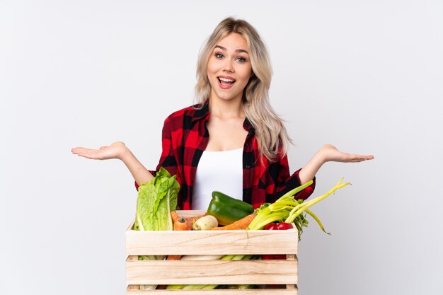 Farmer holding fresh vegetables in a wooden basket