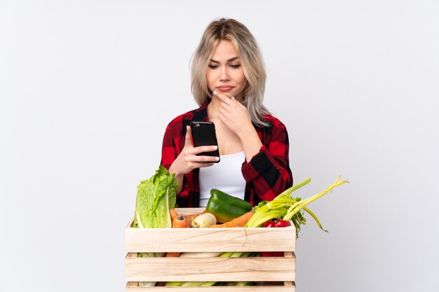 Farmer holding fresh vegetables in a wooden basket