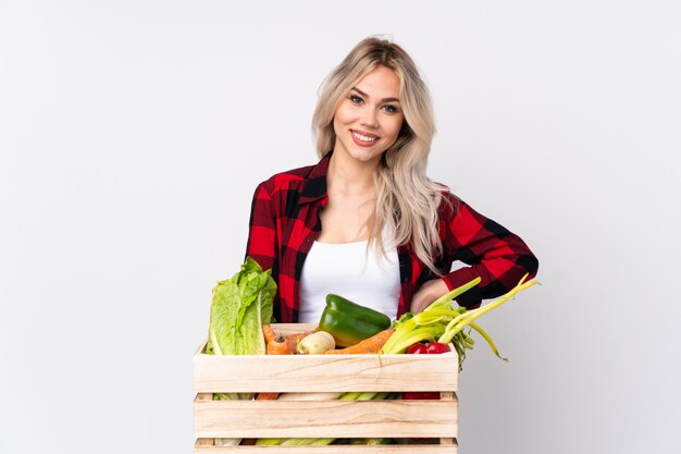 Farmer holding fresh vegetables in a wooden basket