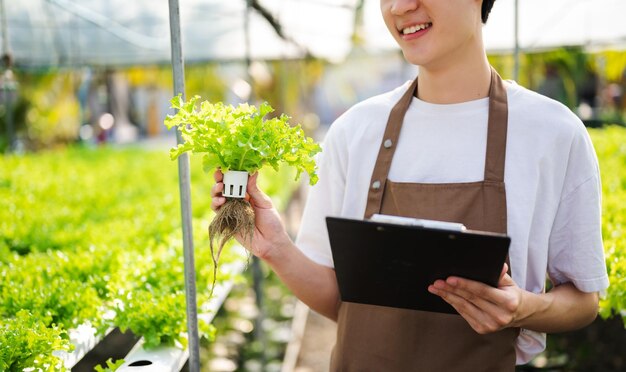 Farmer man using digital tablet computer in field technology application in agricultural growing activity