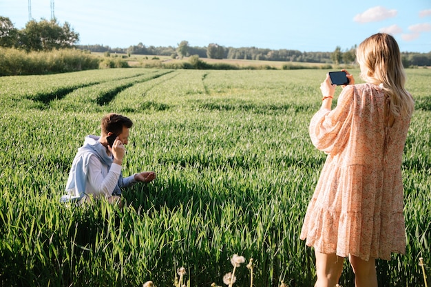  farmer's wife records video on smartphone for their social networks. joint small business concept