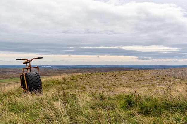 A farmer sits in a field with his tractor