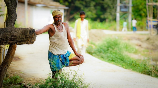 Farmer standing road side image