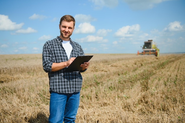 Farmer Standing In Wheat Field At Harvest