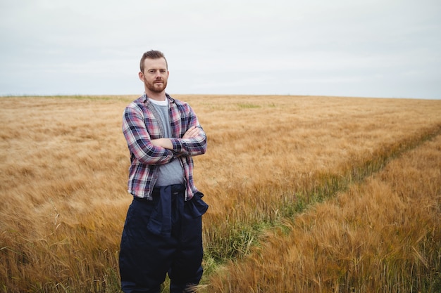  farmer standing with arms crossed in the field