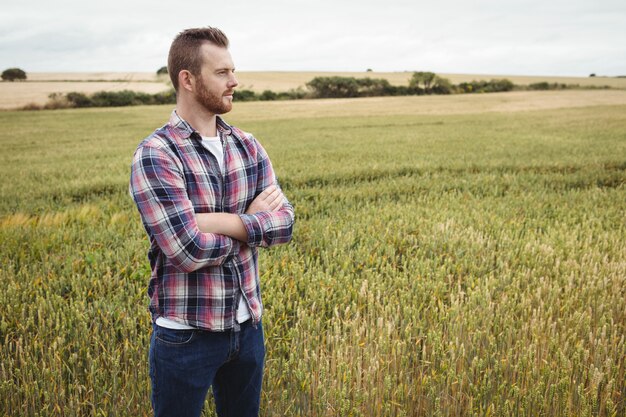  farmer standing with arms crossed in the field