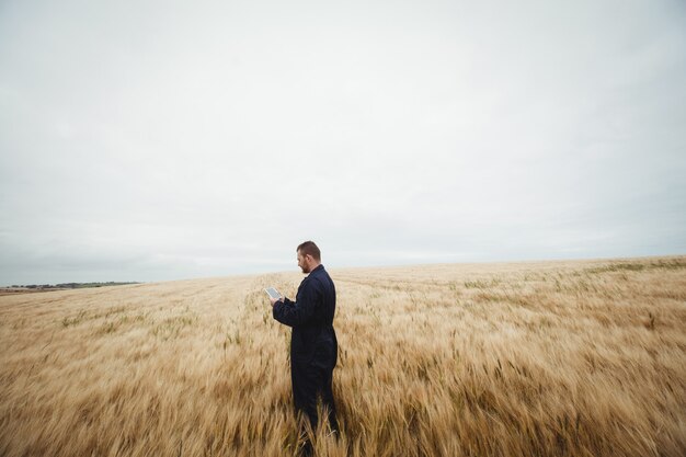 Farmer using digital tablet in the field