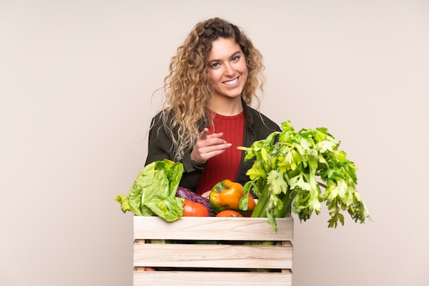 Farmer with freshly picked vegetables in a box