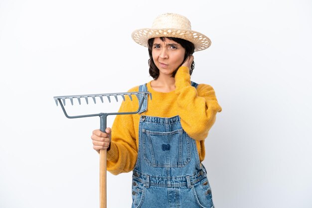 Farmer woman isolated on white background having doubts