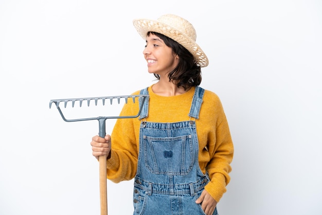 Farmer woman isolated on white background looking to the side and smiling