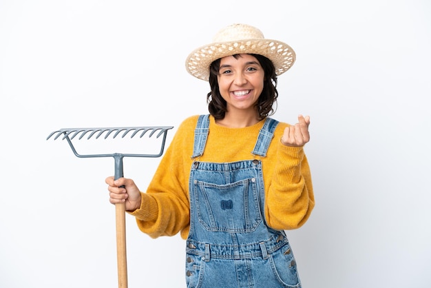 Farmer woman isolated on white background making money gesture