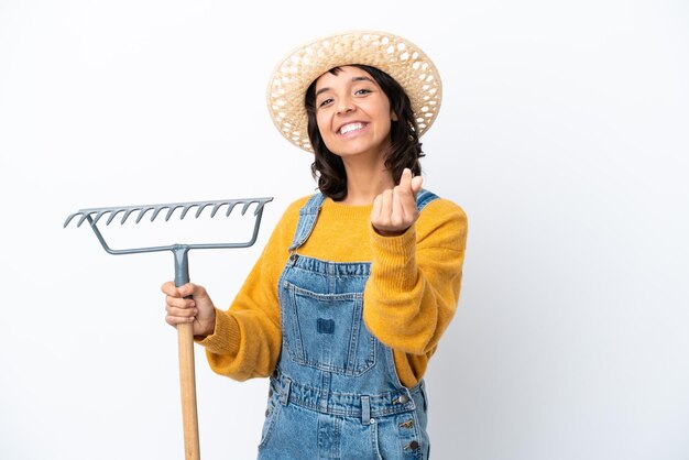 Farmer woman isolated on white background making money gesture