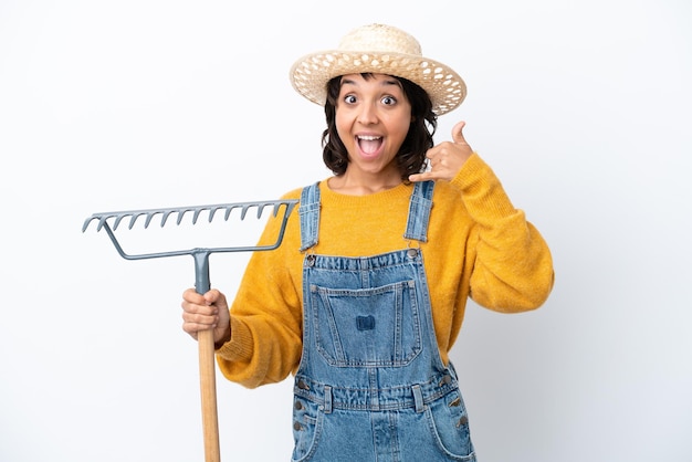 Farmer woman isolated on white background making phone gesture. Call me back sign