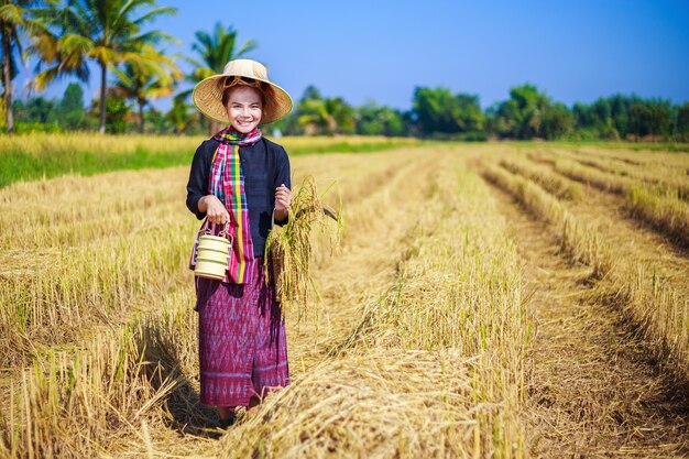 farmer woman with tiffin carrier in rice field