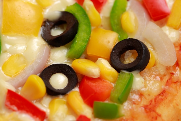 Farmers pizza made using red green and yellow bell pepper