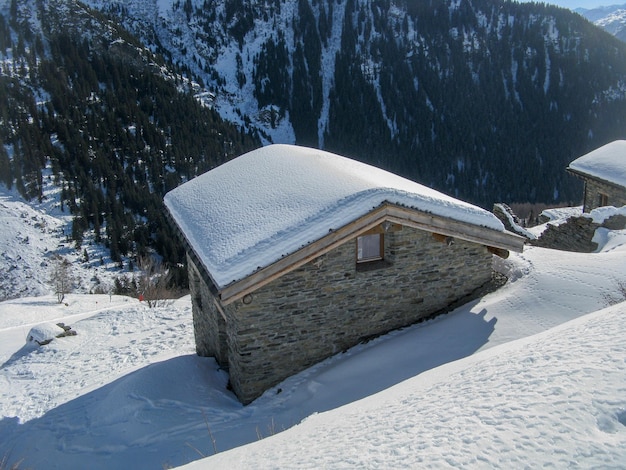 Farmhouse in mountain pasture in winter