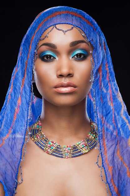 Fascinating beauty. Beautiful African woman covering head by scarf and looking at camera 