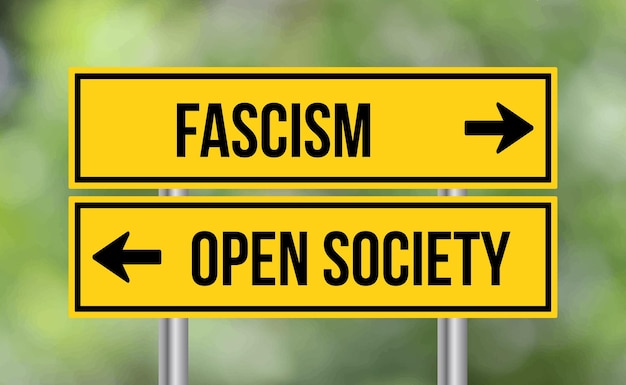 Fascism or open society road sign on blur background