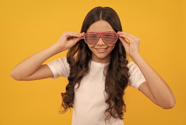 Fashion accessory going crazy childhood happiness fancy party look happy funny kid in glamour eyeglasses with rhinestones funky teen girl having fun cheerful child in glasses beauty portrait