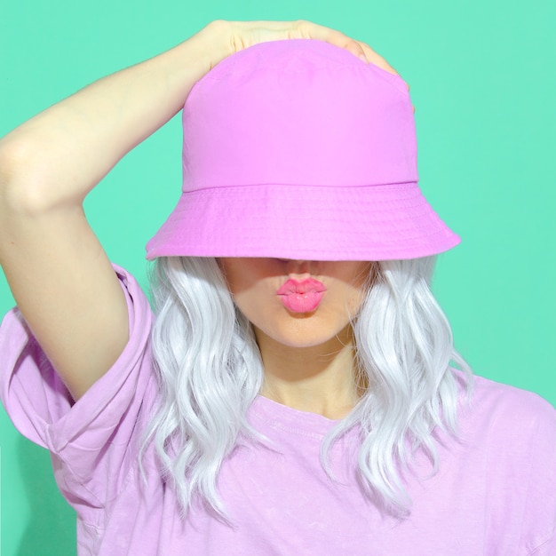 Photo fashion aesthetic girl in trendy summer accessories. bucket hat. street style. urban. vanilla pastel colours