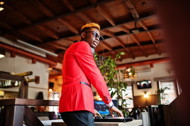 Fashion african american man model DJ at red suit with dj controller