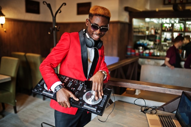 Fashion african american man model DJ at red suit with dj controller