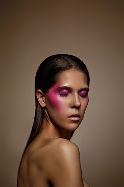 Fashion art skin woman face portrait closeup Glamour shiny professional makeup girl with trendy pink makeup